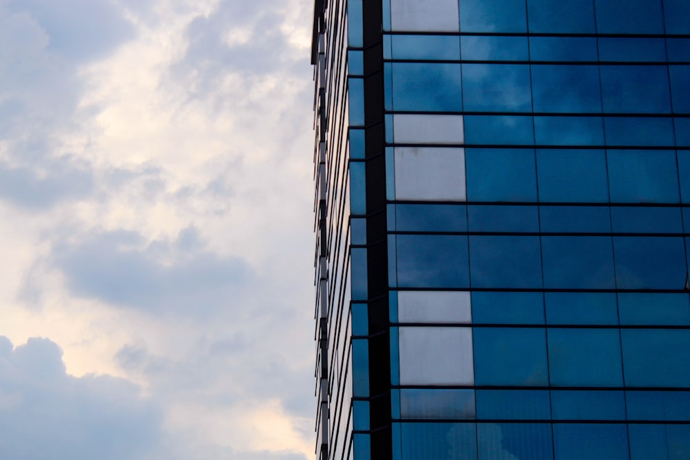 blue and white concrete building under gray sky