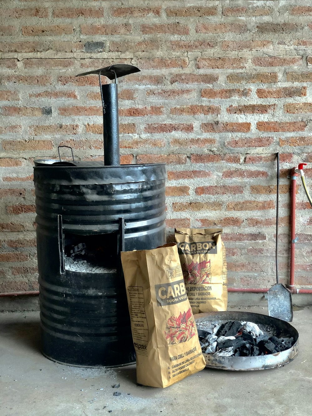 black plastic water tank beside brown cardboard box