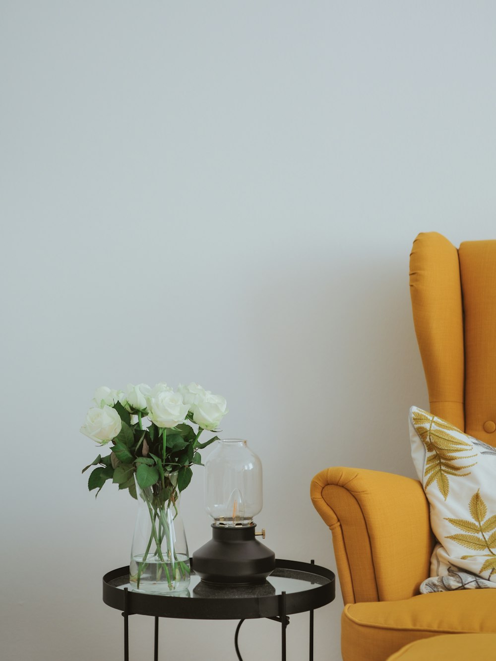 white rose in clear glass vase on table