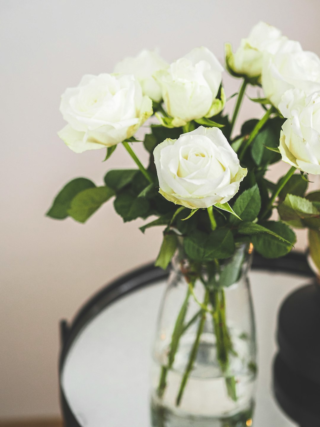 white roses on glass vase