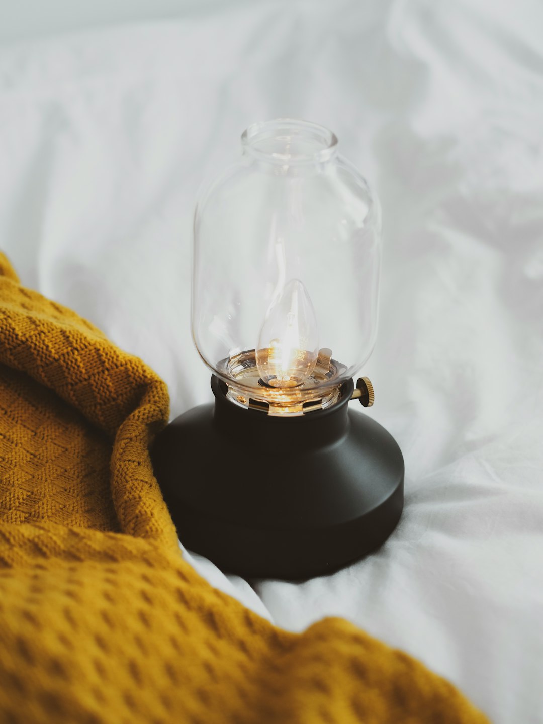 black candle holder on white textile