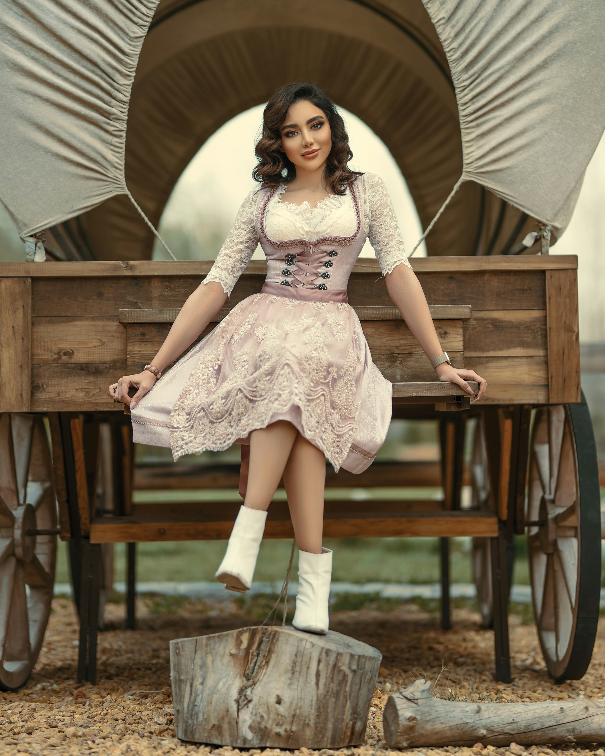 woman in white floral dress sitting on brown wooden bench