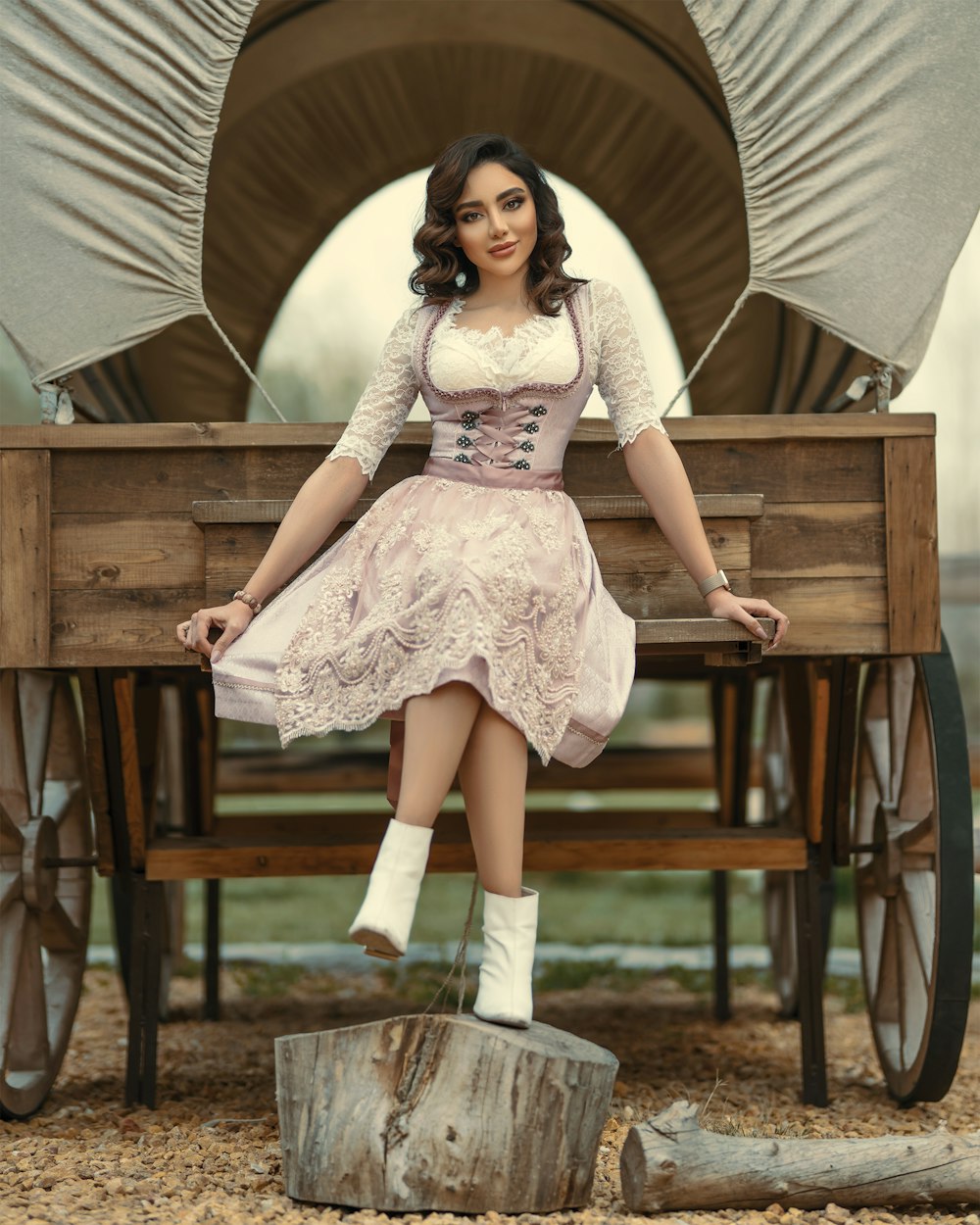 woman in white floral dress sitting on brown wooden bench