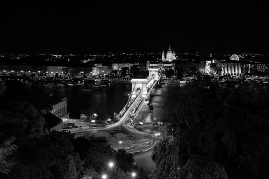 grayscale photo of bridge and city in Széchenyi Chain Bridge Hungary