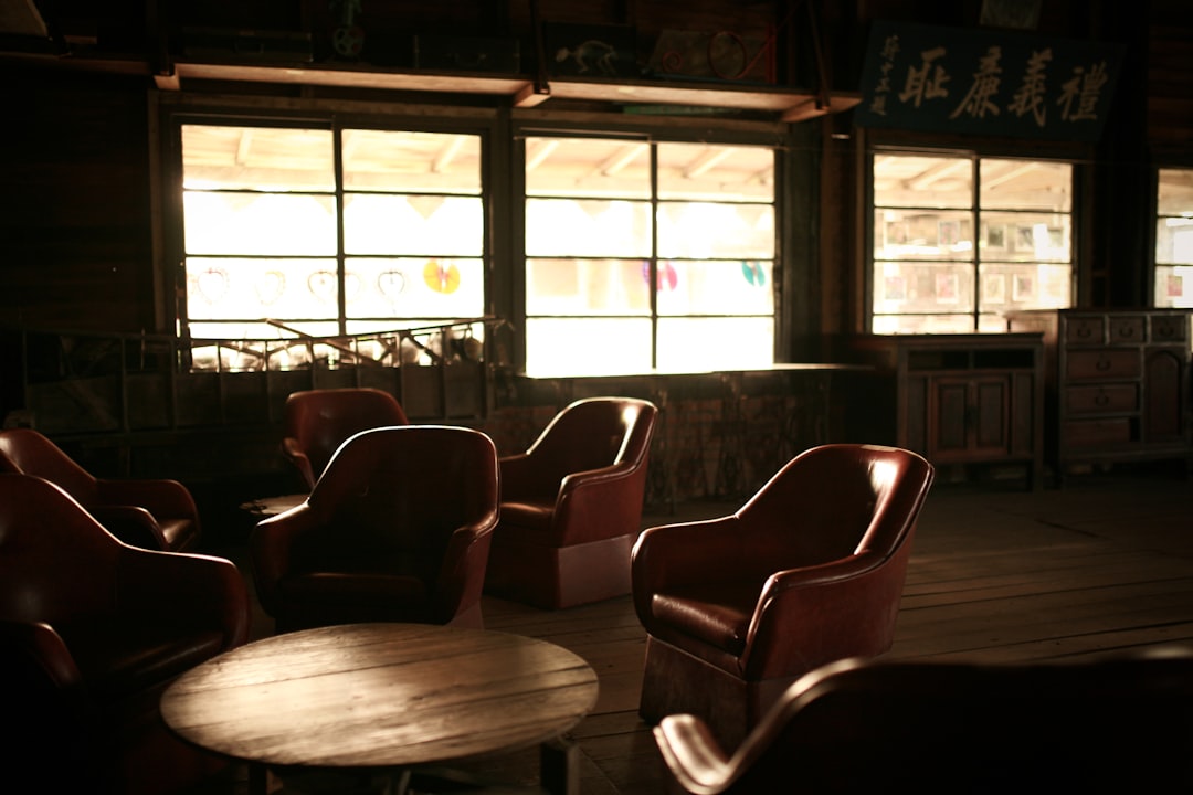 2 men sitting on brown wooden chair