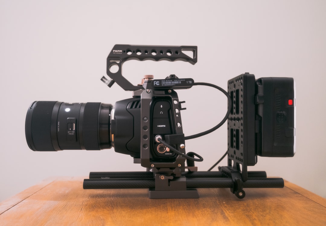 black dslr camera on brown wooden table