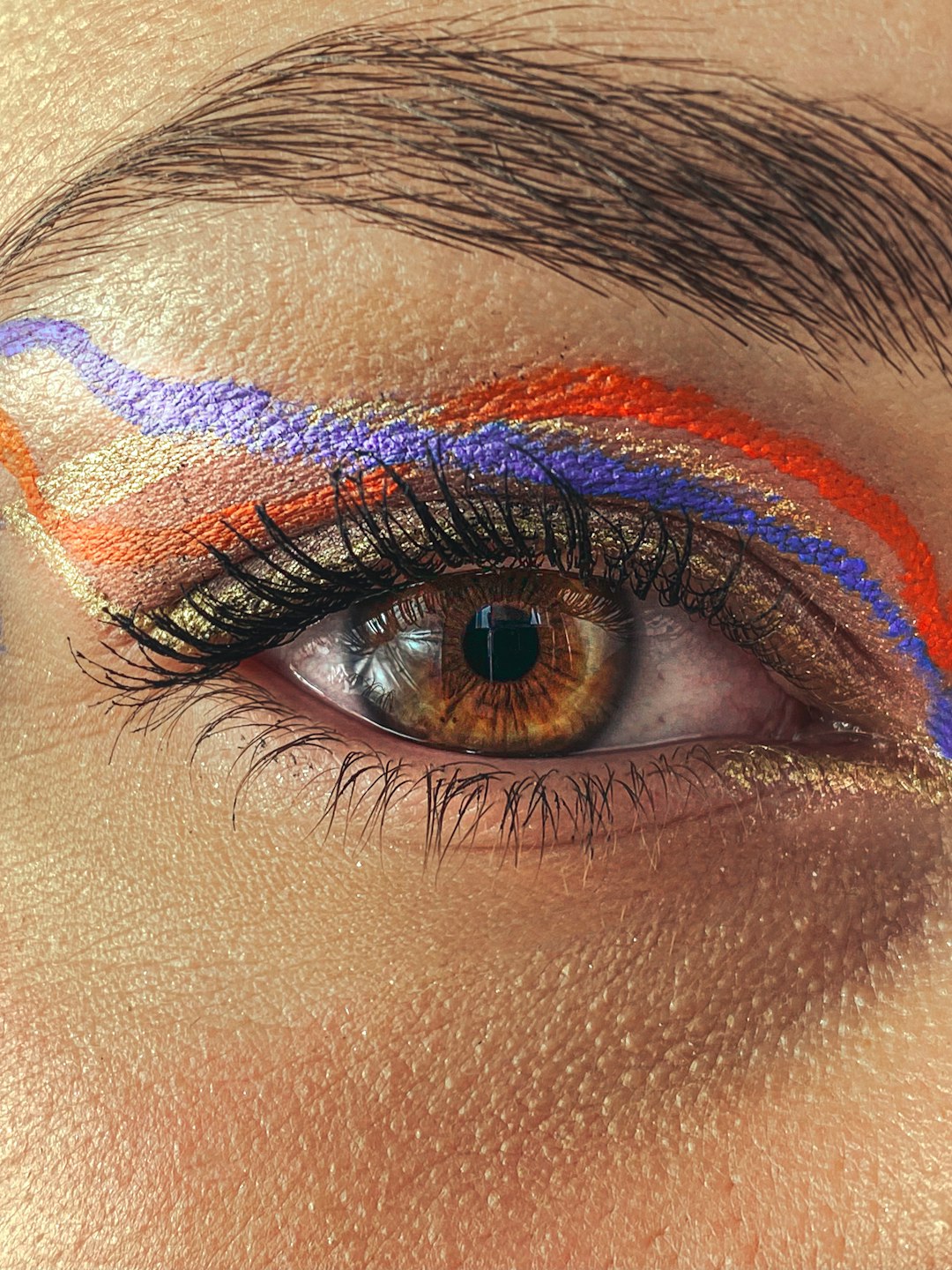 person with blue and red eye shadow