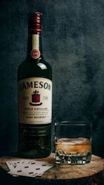 a bottle of jameson next to a glass of whiskey