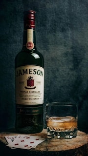 a bottle of jameson next to a glass of whiskey