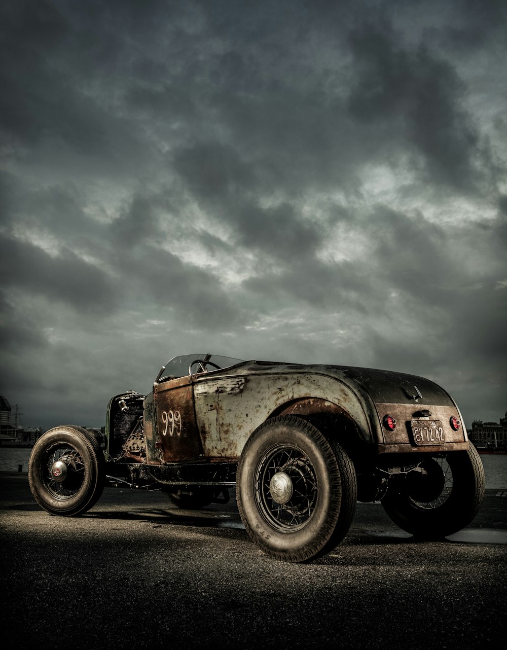 brown car on gray asphalt road under gray cloudy sky