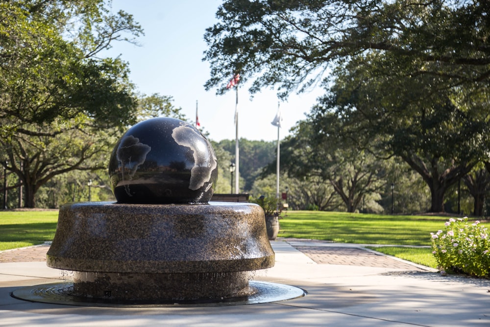 blue globe on brown fountain during daytime