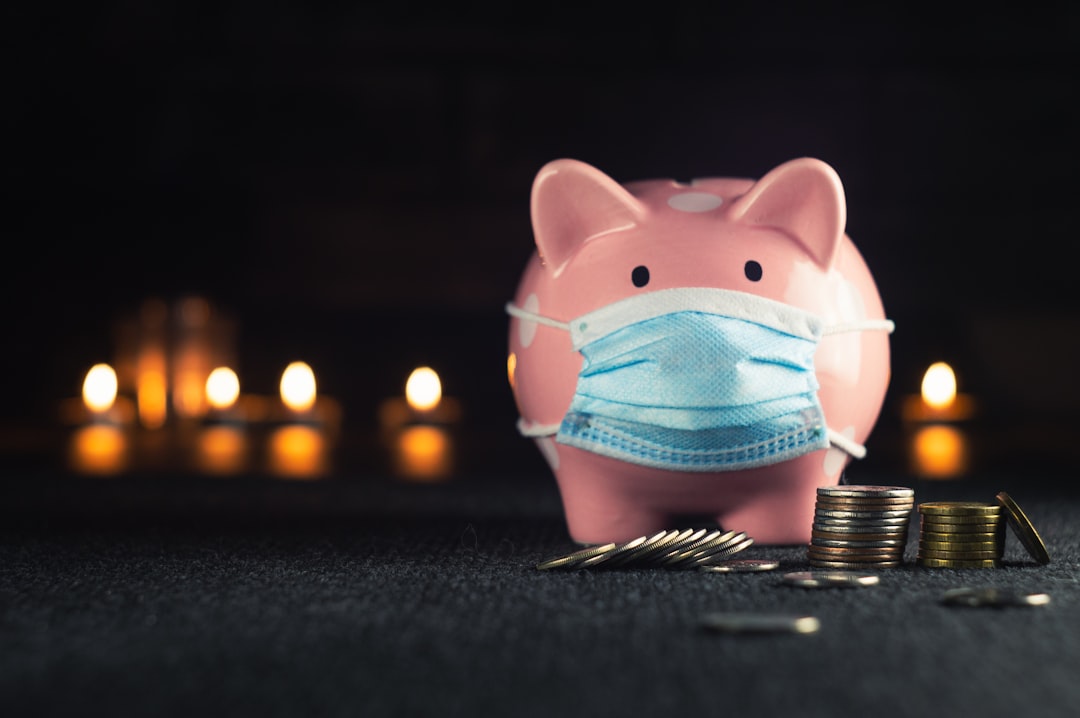 pink and blue pig figurine, Piggy bank in a mask on a background of blurry lights