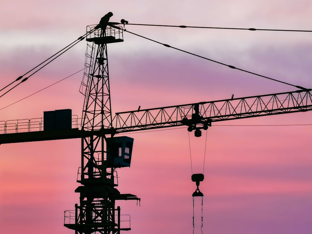 black and red metal crane under blue sky