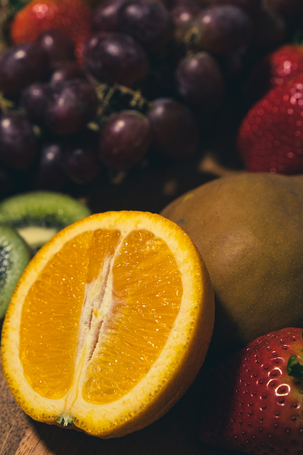 orange fruit beside green citrus fruit