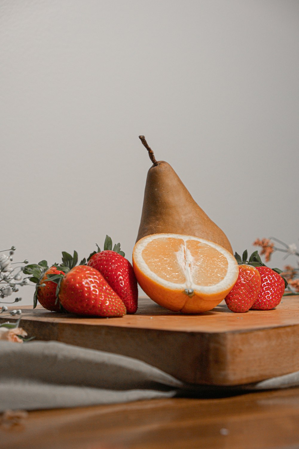 sliced orange fruit on brown wooden chopping board