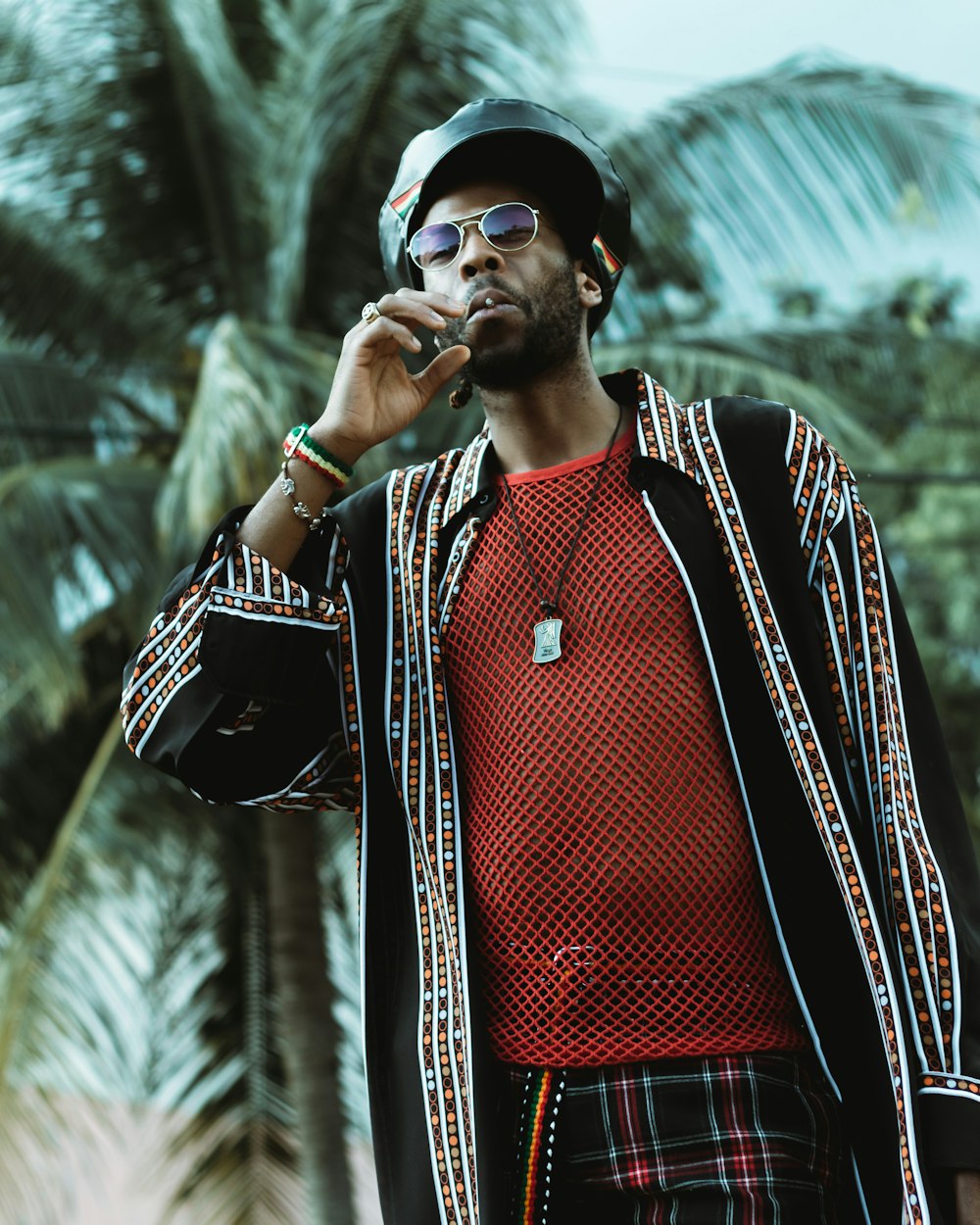 man in red and black zip up jacket wearing black sunglasses