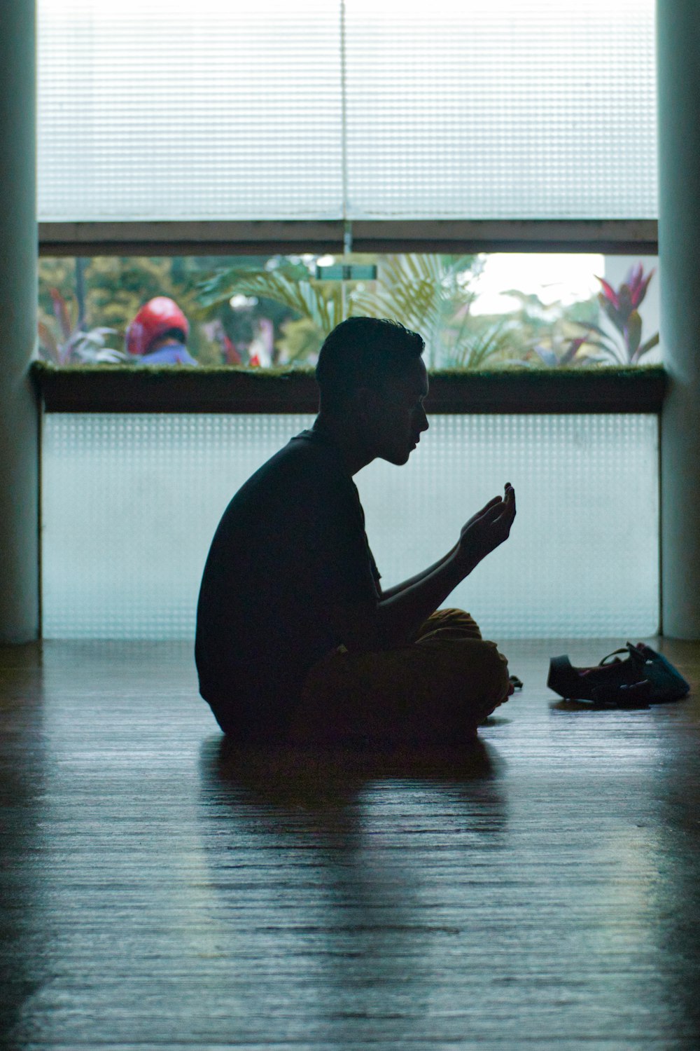 man in black shirt sitting on floor