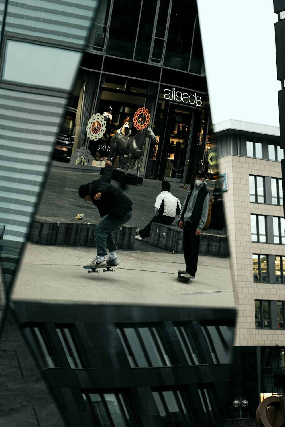 man in black jacket and black pants walking on sidewalk during daytime