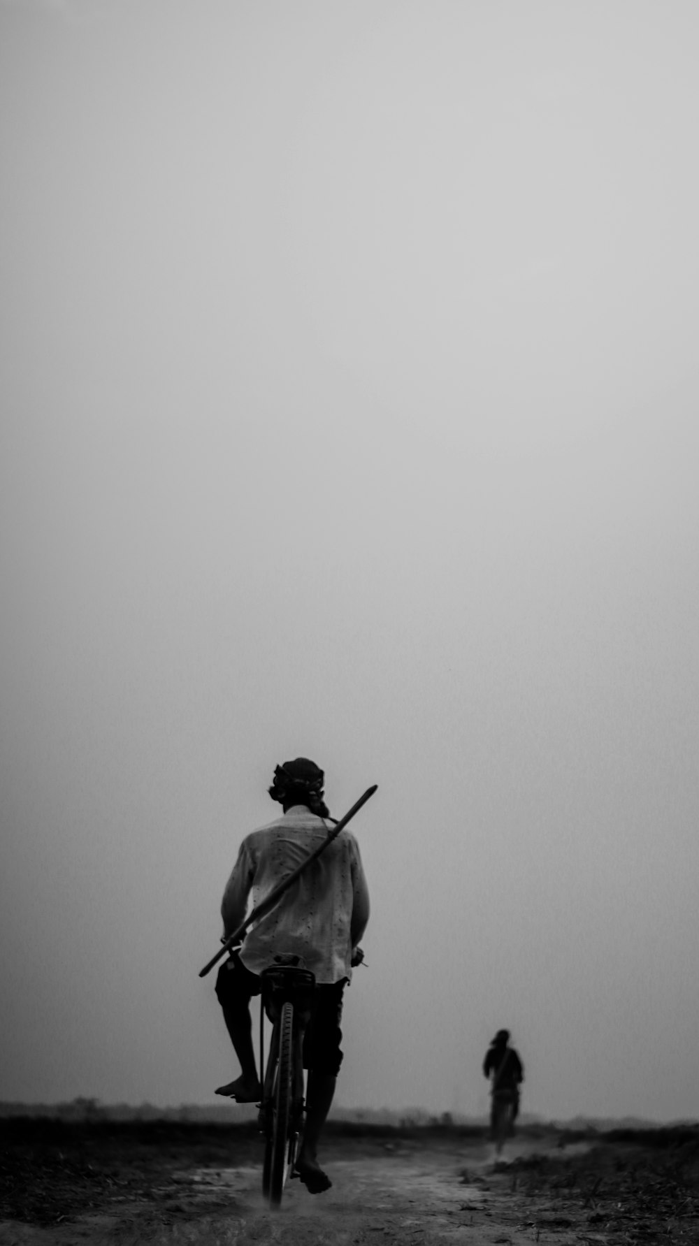 man in black jacket holding stick