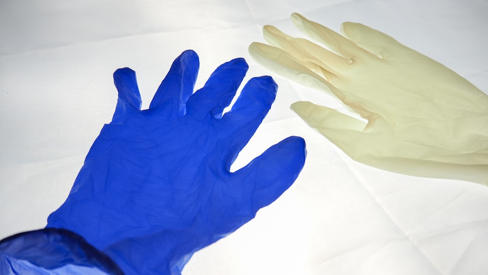 persons hand on white textile