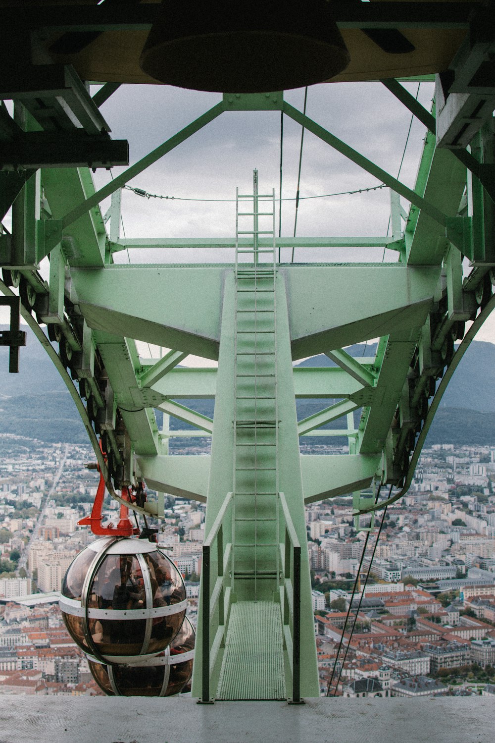 people in a green metal tower during daytime