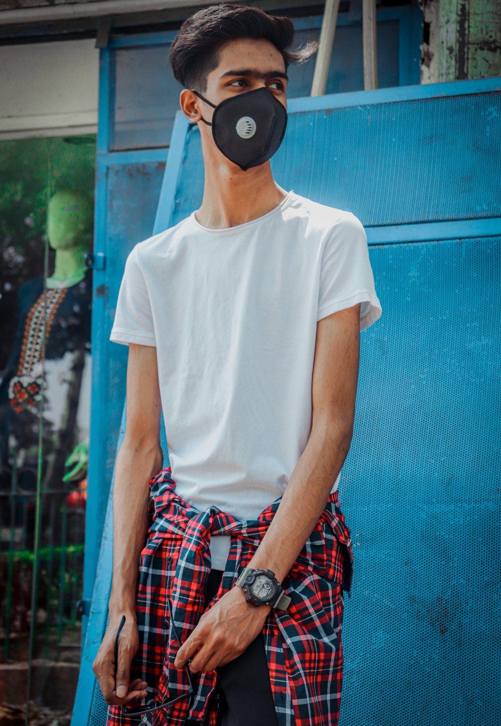 man in white crew neck t-shirt wearing black and blue headphones