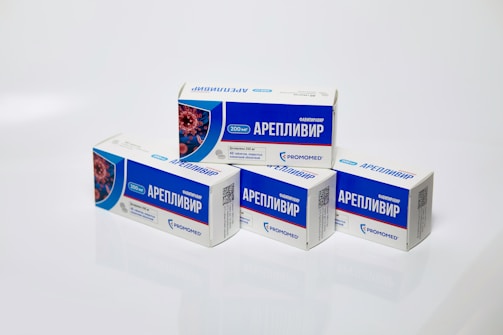 Several boxes of Areplivir medication are displayed on a clean white surface. Each box features prominent blue and white colors with text in a foreign language. The design includes an image resembling a microscopic view of a virus.