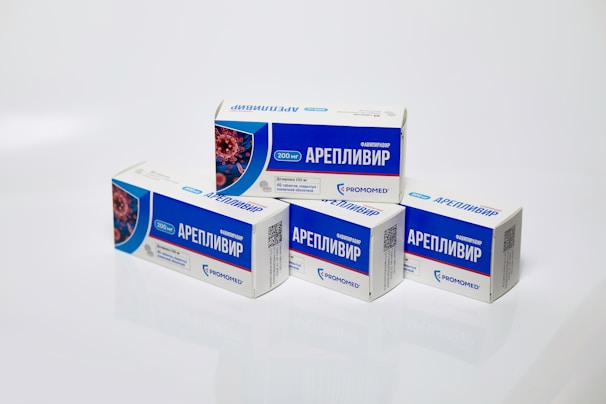 Several boxes of Areplivir medication are displayed on a clean white surface. Each box features prominent blue and white colors with text in a foreign language. The design includes an image resembling a microscopic view of a virus.