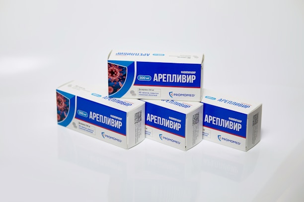 Several boxes of Areplivir medication are displayed on a clean white surface. Each box features prominent blue and white colors with text in a foreign language. The design includes an image resembling a microscopic view of a virus.