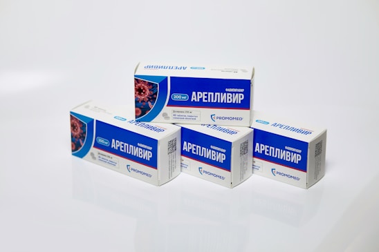 Several boxes of Areplivir medication are displayed on a clean white surface. Each box features prominent blue and white colors with text in a foreign language. The design includes an image resembling a microscopic view of a virus.
