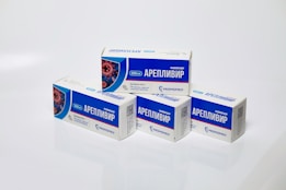 Several boxes of Areplivir medication are displayed on a clean white surface. Each box features prominent blue and white colors with text in a foreign language. The design includes an image resembling a microscopic view of a virus.