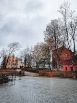 A panoramic shot of a quiet, overlooked city corner with scattered leaves and fading paint.