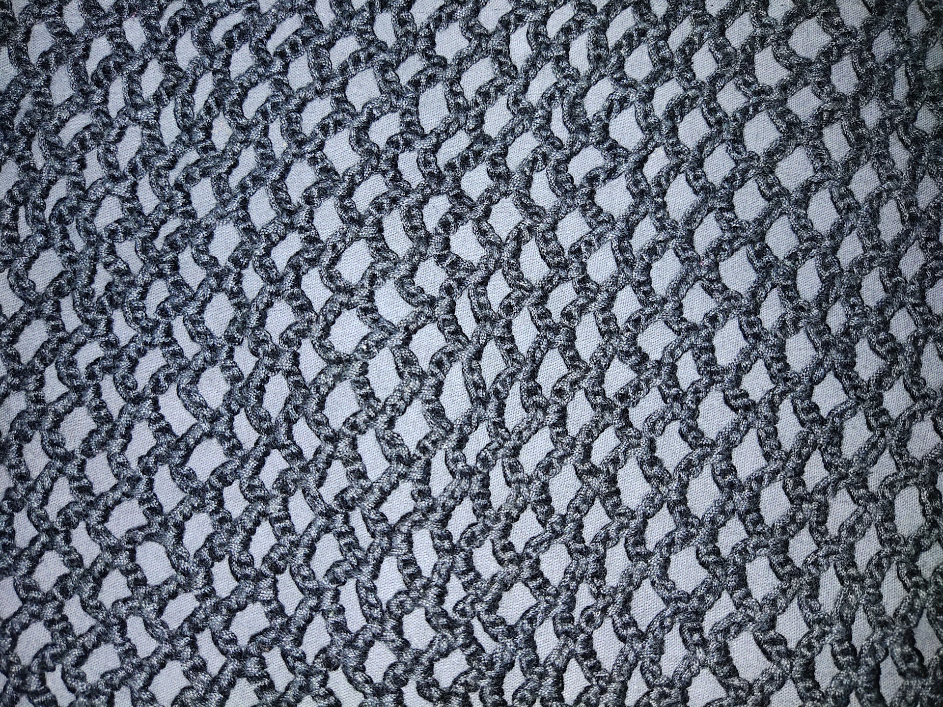 Close-up of a graphite nylon gasket (PA6) showing its textured surface and layered structure.