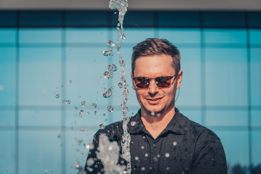 man in black button up shirt wearing black sunglasses