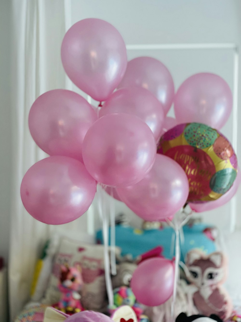 pink balloon near white window