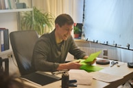 A friendly agent assisting a client with paperwork in a welcoming office.