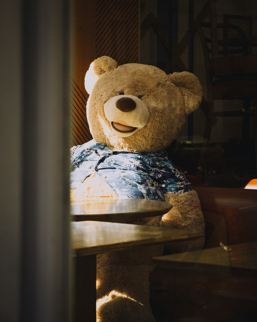 brown bear plush toy on brown wooden table