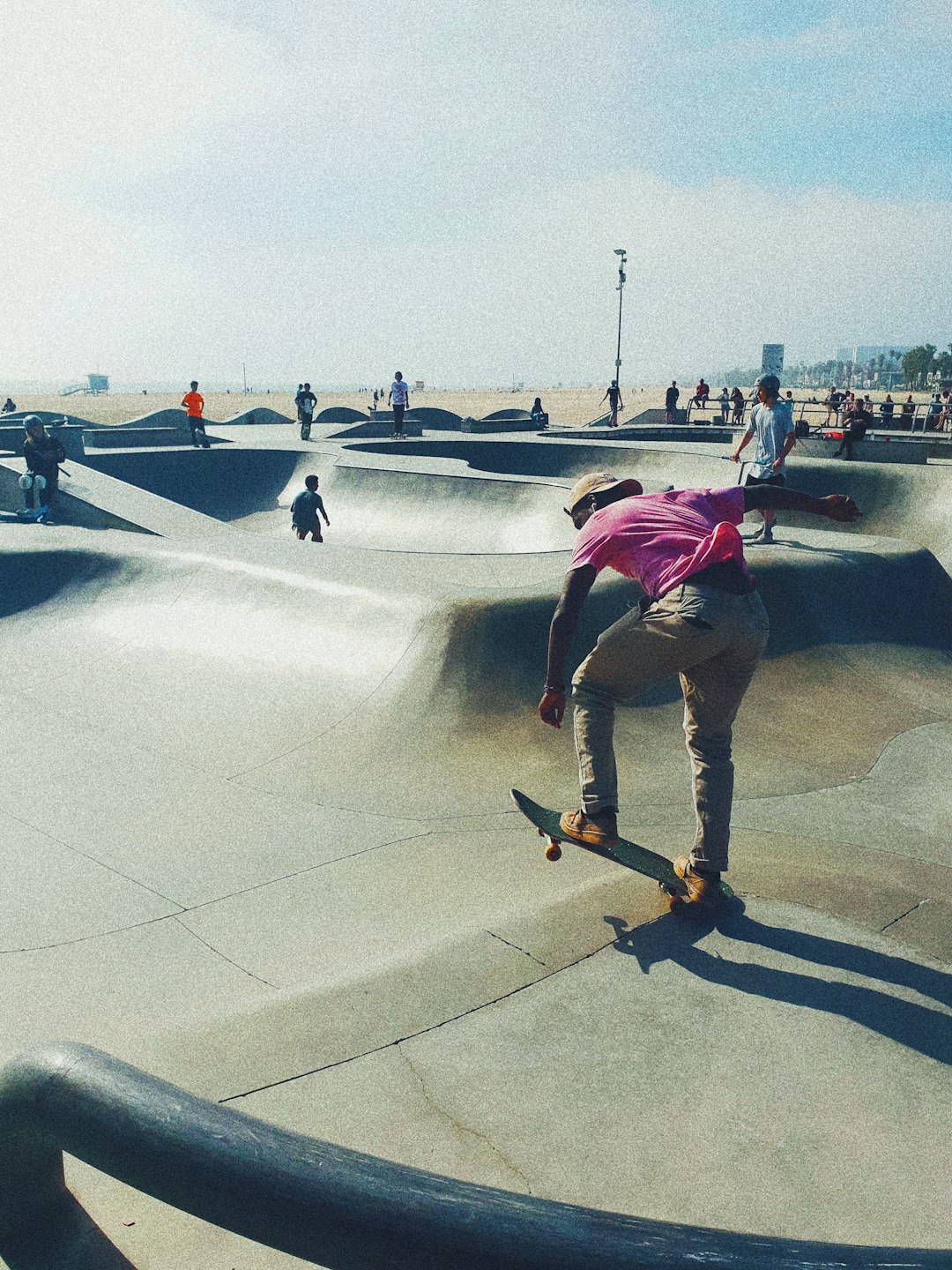 man in green t-shirt and brown pants riding skateboard during daytime