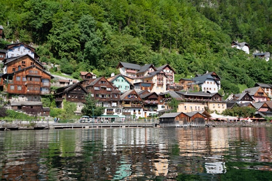 houses near body of water during daytime in Hallstatt Austria Austria