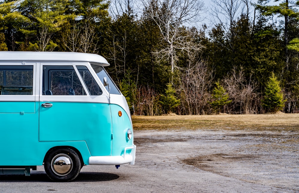 blue and white volkswagen t-2 parked on the side of the road