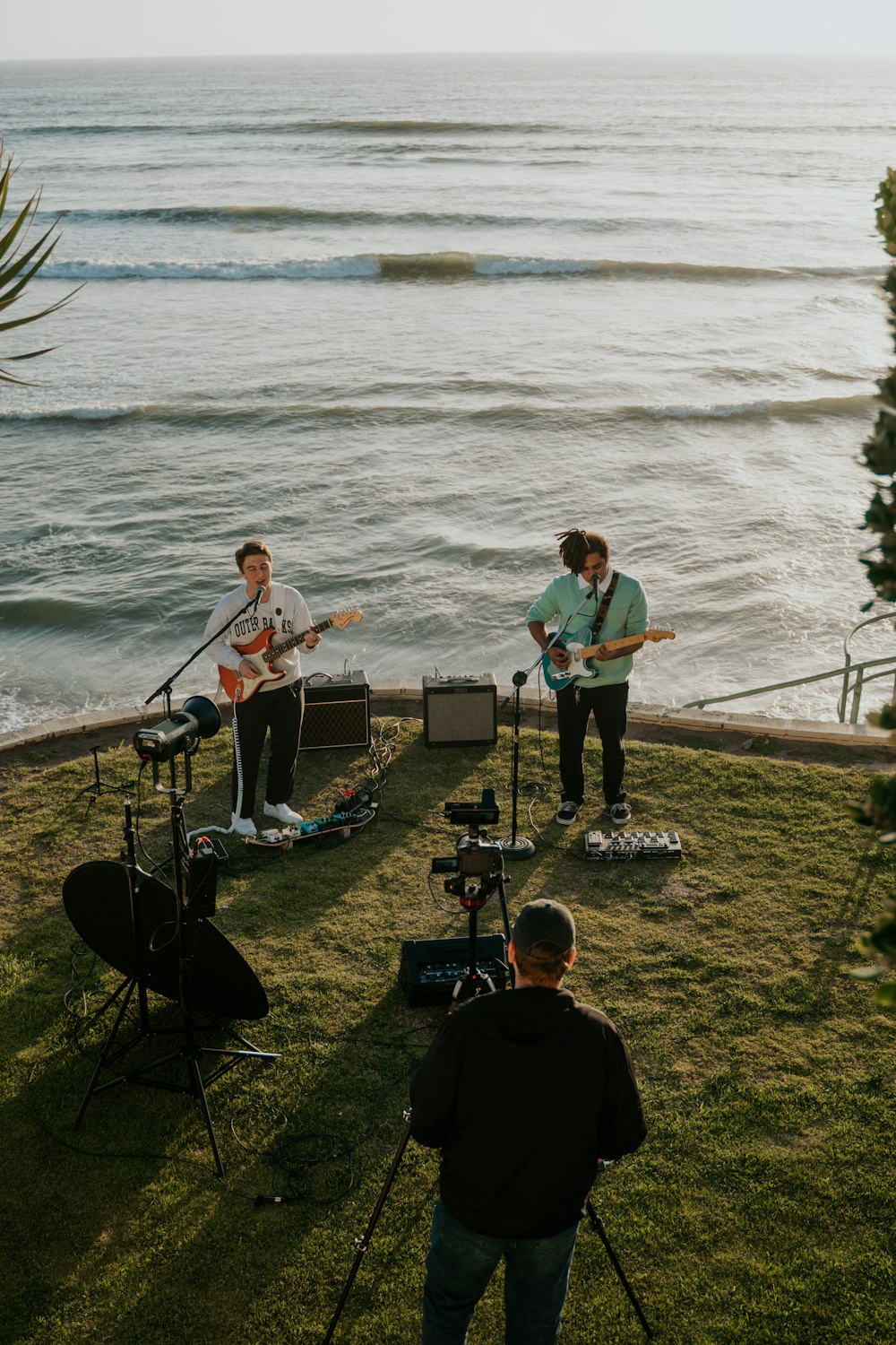 man in blue crew neck t-shirt playing guitar