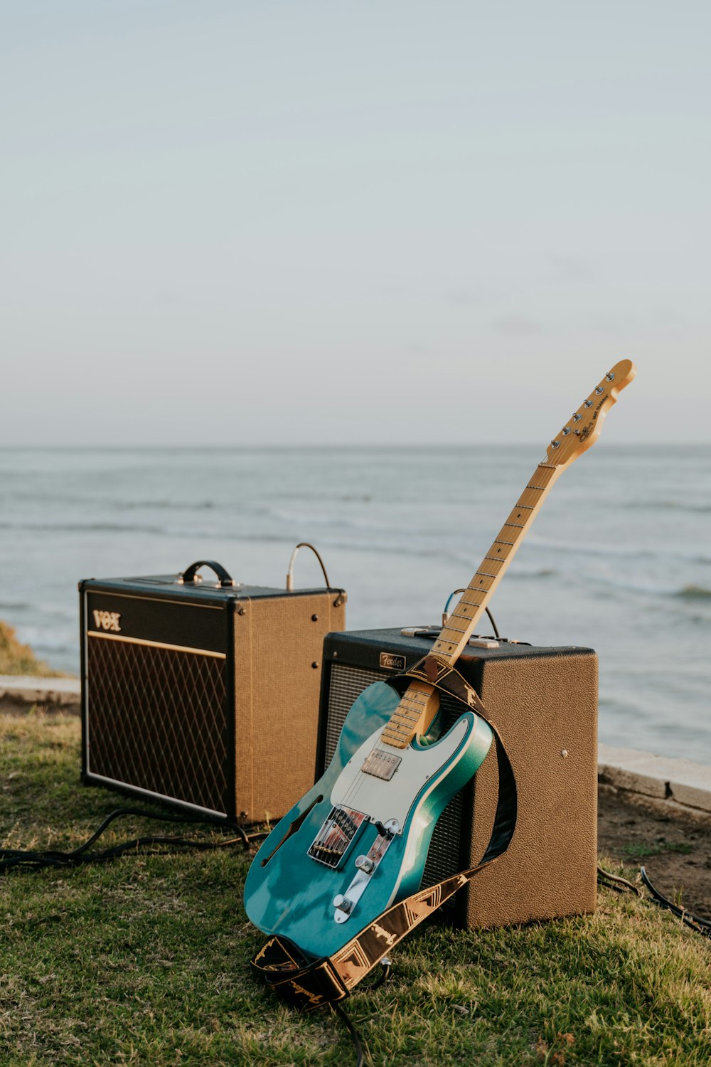 brown and black guitar amplifier on brown wooden dock during daytime