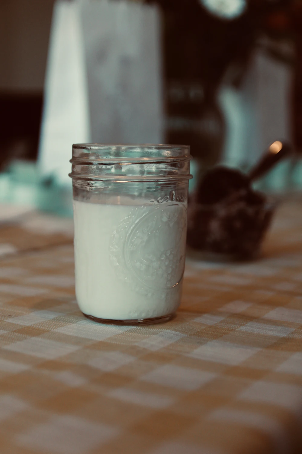 A glass of fresh milk on a light surface