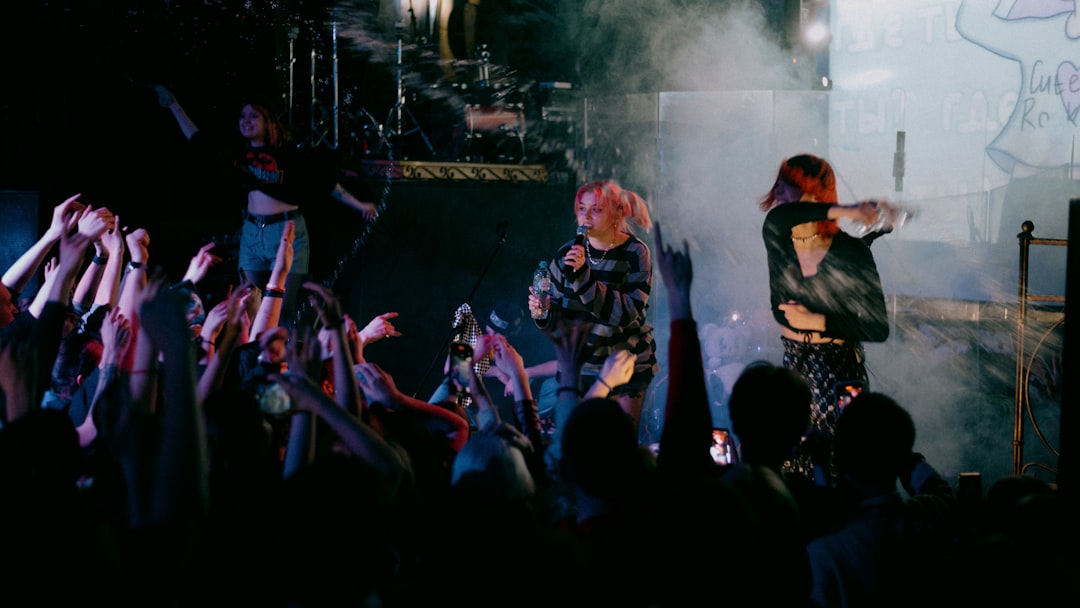 people in black and yellow jackets standing on stage