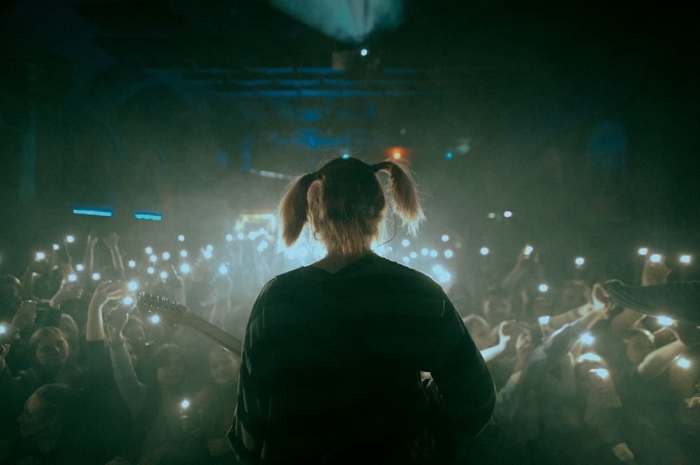 man in black shirt standing in front of crowd