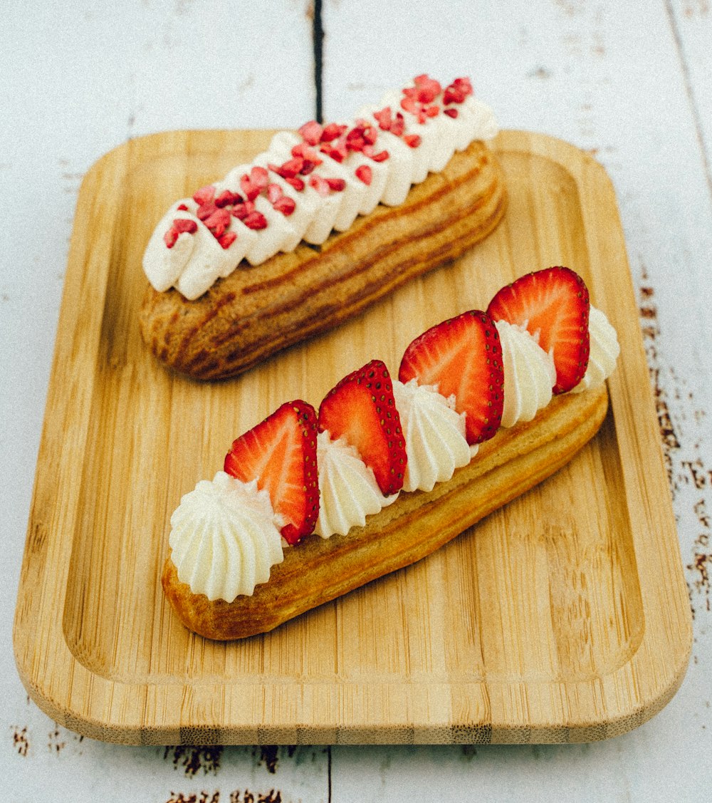 sliced strawberry and strawberry on brown wooden chopping board