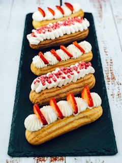 A selection of colorful eclairs displayed elegantly on a tray.