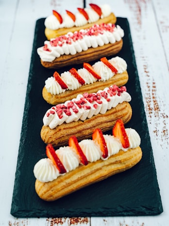 A selection of colorful eclairs displayed elegantly on a tray.