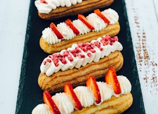 white and red pastry on black wooden table