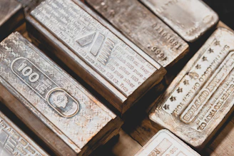 Elegant close-up of gold and silver bars stacked on a dark surface with subtle Swiss elements.